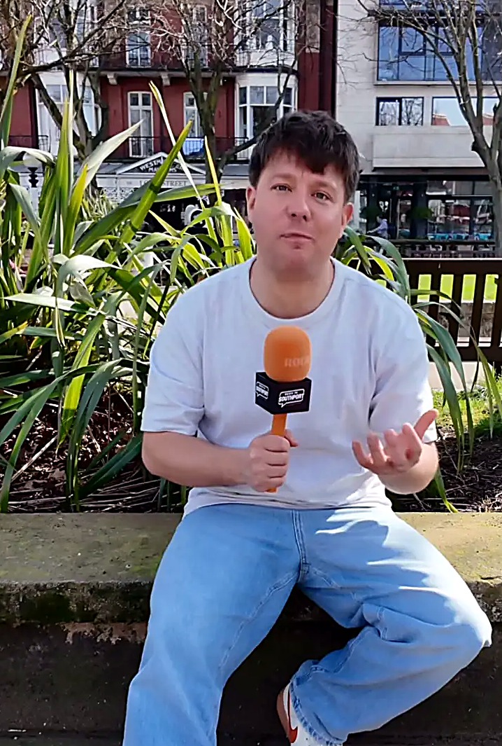 Seen In Southport presenter filming a piece to camera on Lord Street, Southport